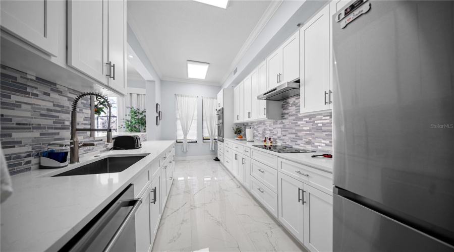 Kitchen - Quartz Countertops and Stainless Steel Appliances featuring Select Kitchen Aid Units