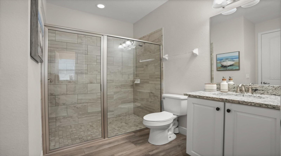 Bathroom with granite countertops and modern finishes continuing the home’s upscale feel.