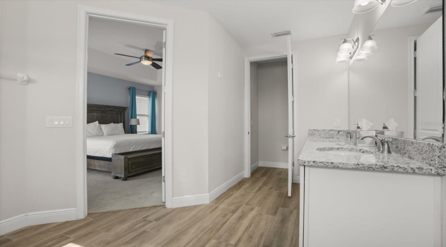 Vanity and bathroom area with generous counter space and storage.