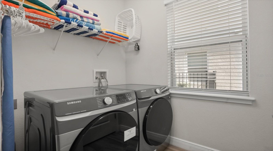 Laundry area with storage space for added convenience during extended stays or full time living.