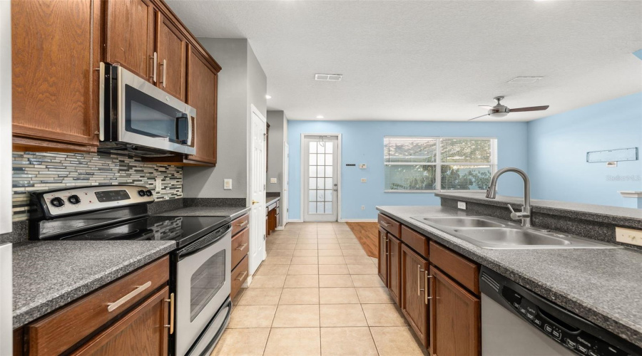 Kitchen looking towards back door of unit that opens to a courtyard.