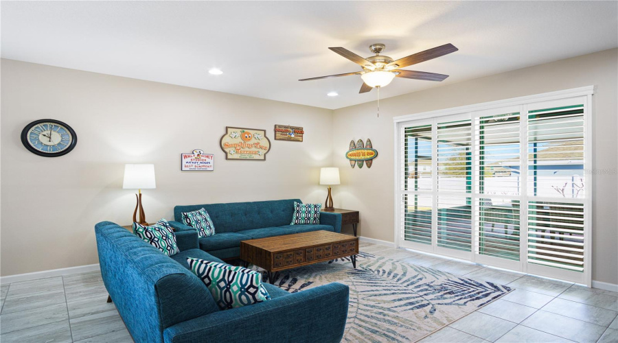 Living room with plantation shutters on the sliding doors.