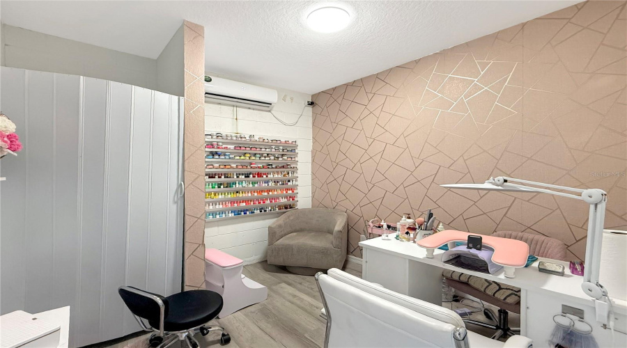 Additional room with AC in the garage used as a nail studio