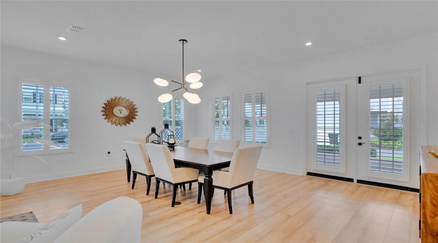 Dining room with shutters, facing spacious back porch.