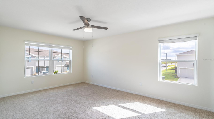 Primary bedroom with ceiling fan