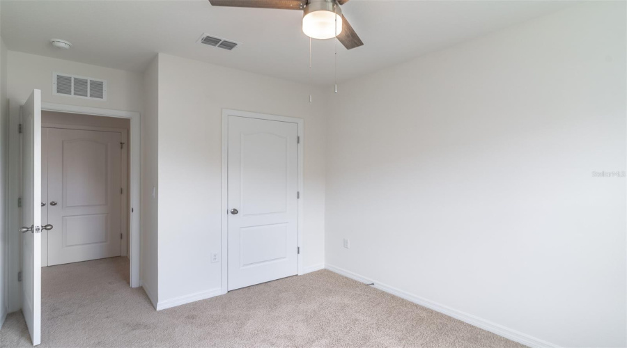 Bedroom three with ceiling fan