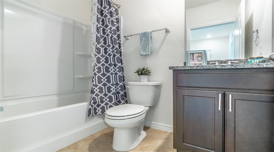 Hallway bathroom with tub/shower combo on upper level