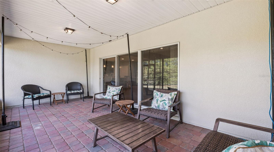 Screened-in lanai with serene water views—perfect for relaxing and entertaining