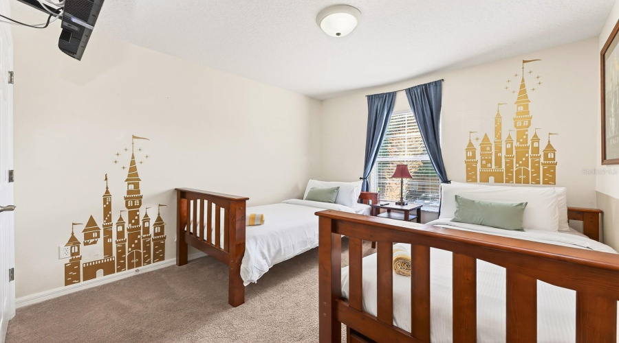Two additional bedrooms, each with fun DISNEY-INSPIRED THEMING, share a generous full bath, making this home especially appealing for vacation guests.