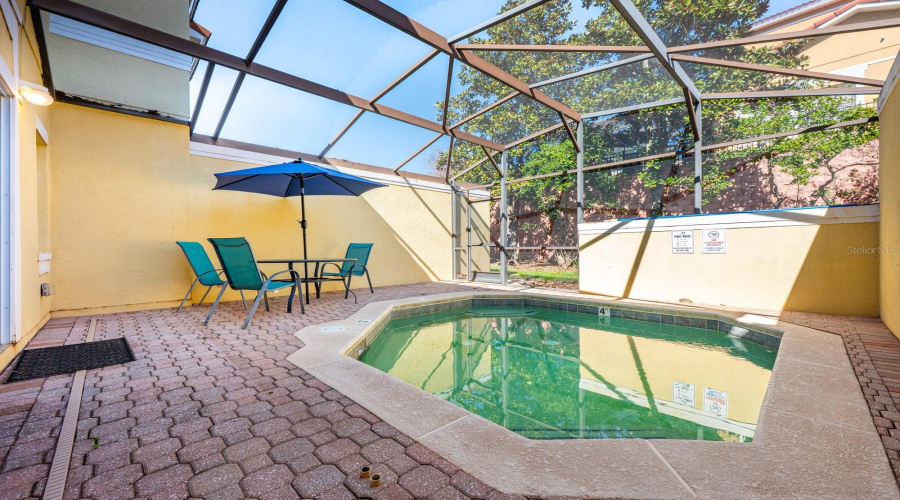 Step outside to the paver patio and your PRIVATE HEATED PLUNGE POOL, all enclosed within a screened lanai, offering a peaceful and private setting—perfect for unwinding after a day at the parks or hosting guests.