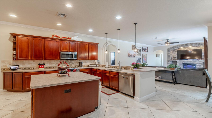 Expansive kitchen island with wind fridge, breakfast bar overlooks the living room