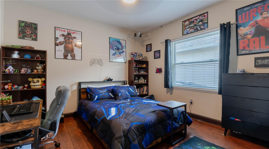 Bedroom 2 with ceiling fan and ample closet space