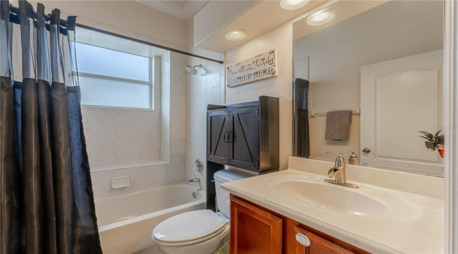 Shared bathroom with tub and shower combo