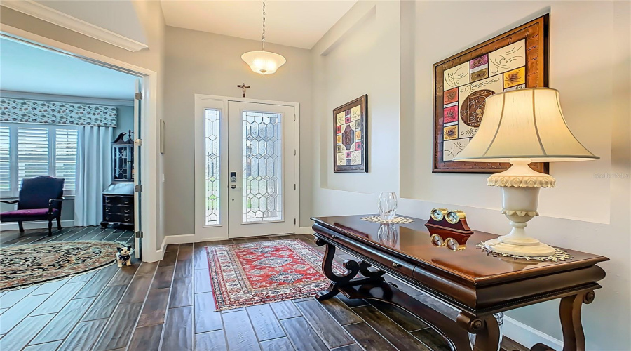 ENTRY FOYER with a LEADED GLASS FRONT DOOR.