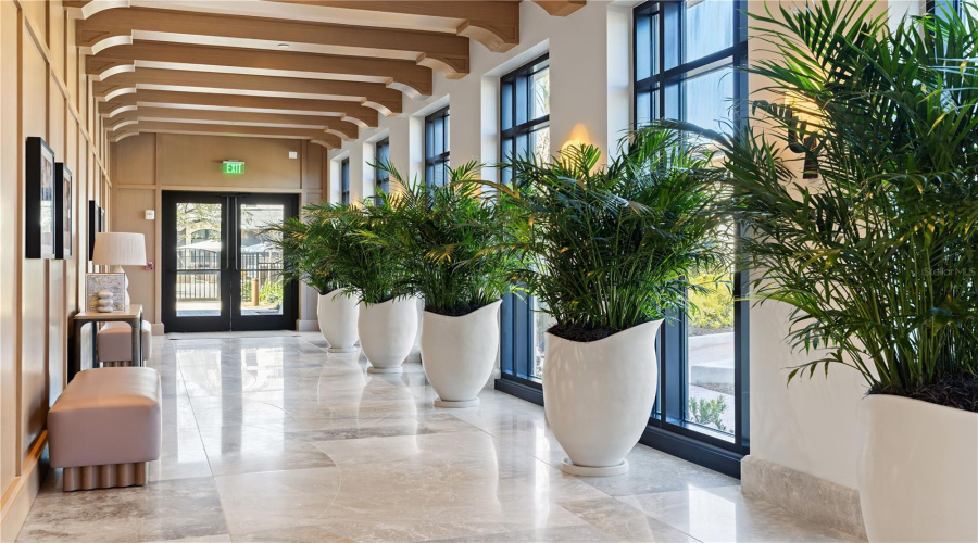 Florian Park Amenities: A Welcomed Arrival. The stage is set for your much-anticipated entrance. A porte-cochere will lead to the open-air lobby, staffed 24/7, so there’s always someone to welcome you home. You’ll delight in the instantly impressive space which features your Residential Services reception area, the resident’s lounge, inspired workspaces, flex rooms for events and a coffee bar.