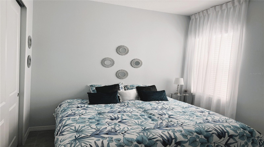 2nd Bedroom - Convertible twin bed shown as King bed - included with home