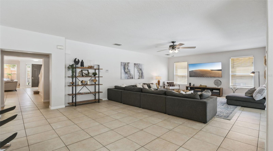 Second living space open to kitchen with TV and room for a large family to relax or entertain.