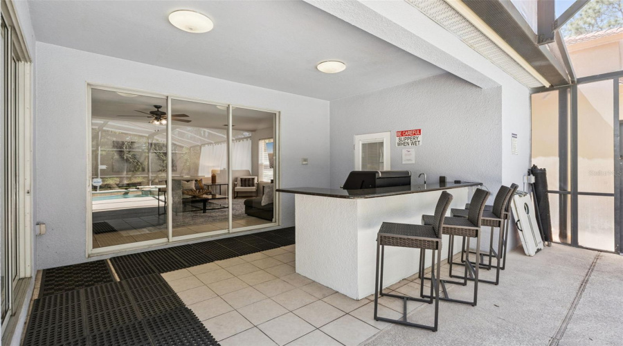 Outdoor kitchen with granite counter and a half-bathroom