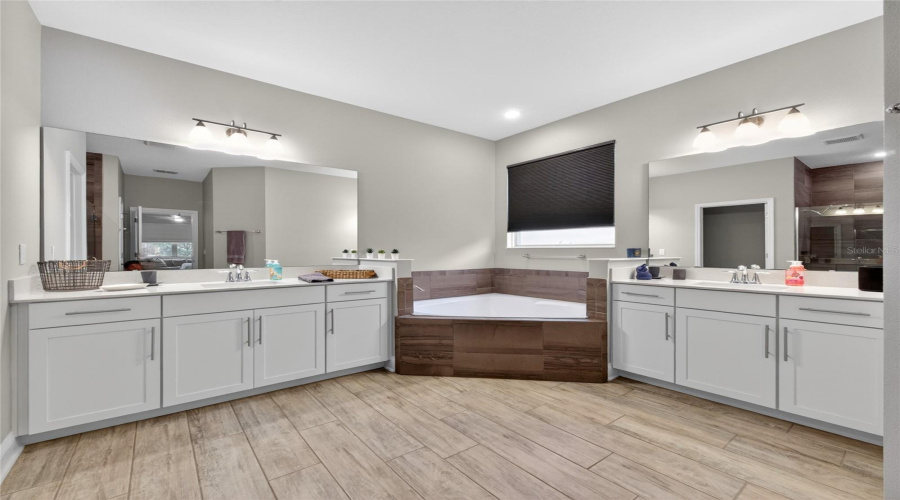 Spa-like Primary Bath with Garden Tub, Two Vanities, and Walk-in Shower