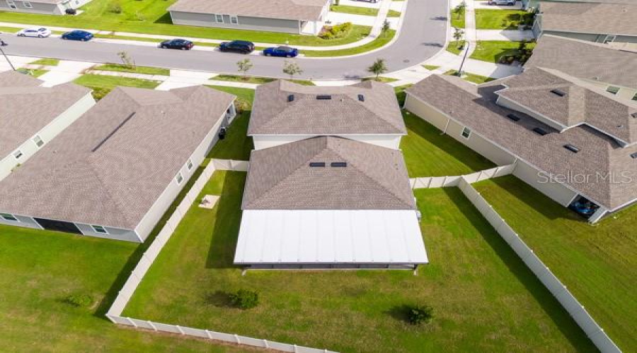 House from rear showing lanai (white) and rear yard (fenced)