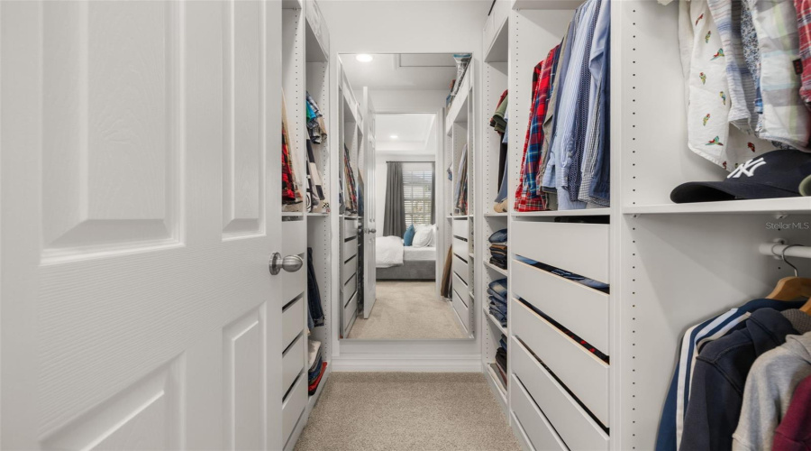 PRIMARY WALK IN CLOSET WITH CUSTOM BUILT IN
