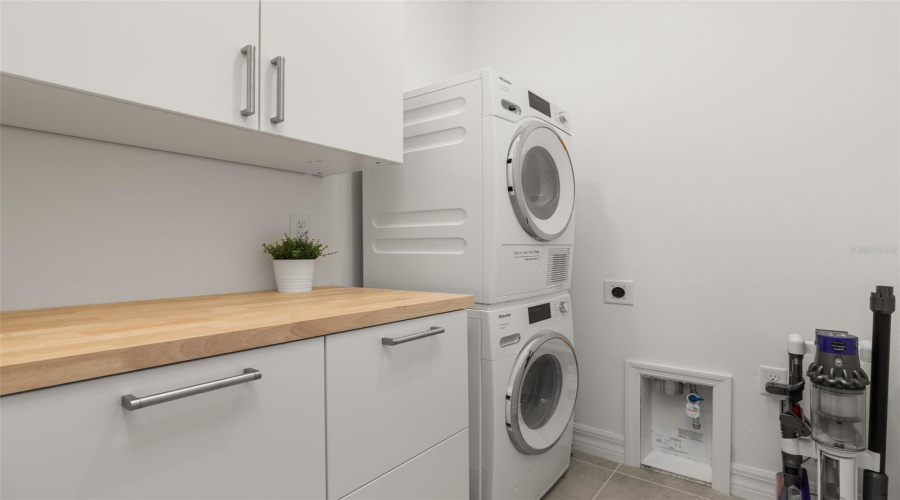 LAUNDRY WITH STACKABLE WASHER/DRYER & BUILT IN CABINETS