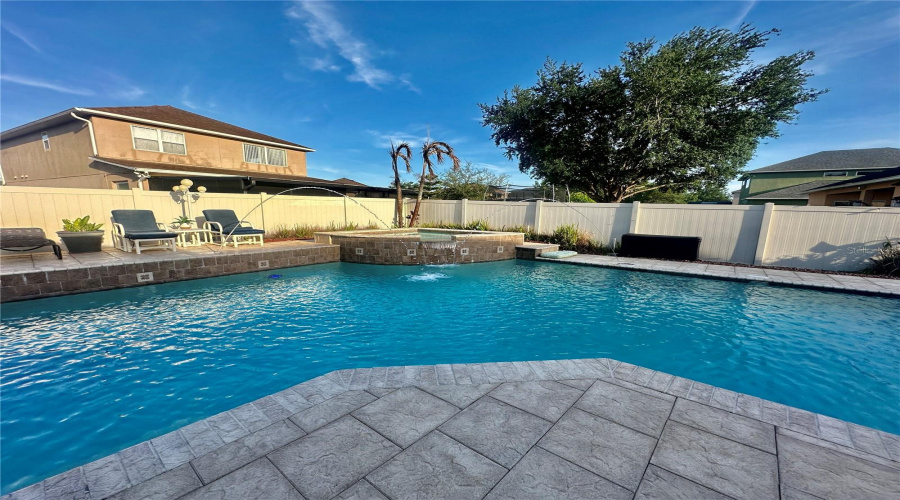 Amazing Pool with hot tub, waterfall, deck jets, and lighting.