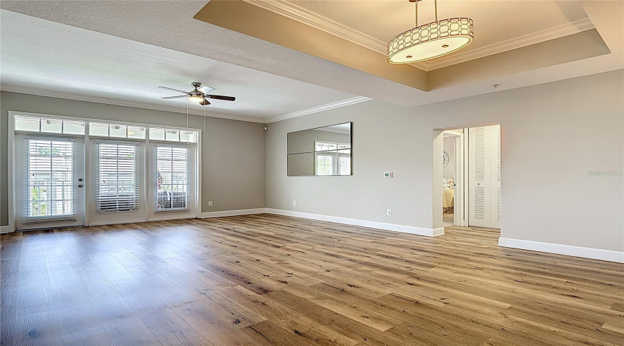 Dining Room with Tray Ceiling and Living Room with French Door to Terrace