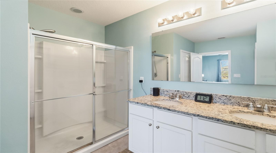 Primary bath en-suite, double vanity, walk in shower, enclose commode, first floor