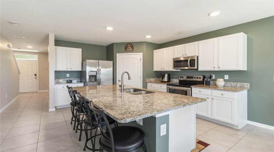 spacious kitchen with pantry and granite countertops