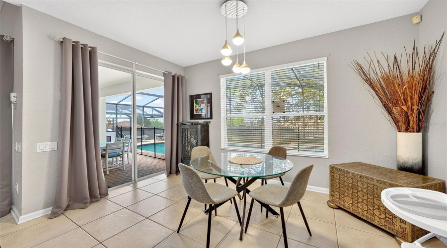 Nook_table_area_with_slider_to_covered_lanai_and_screened_poolspa