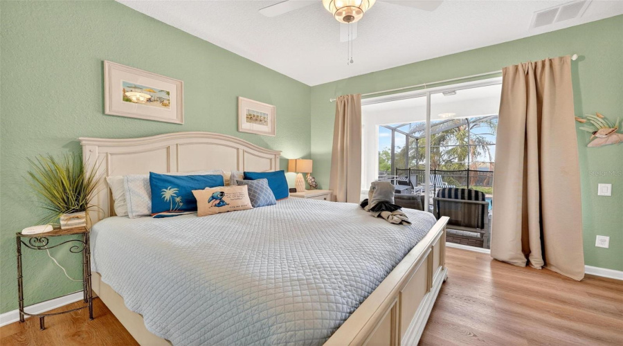 Primary_bedroom_with_slider_to_covered_lanai_and_poolspa