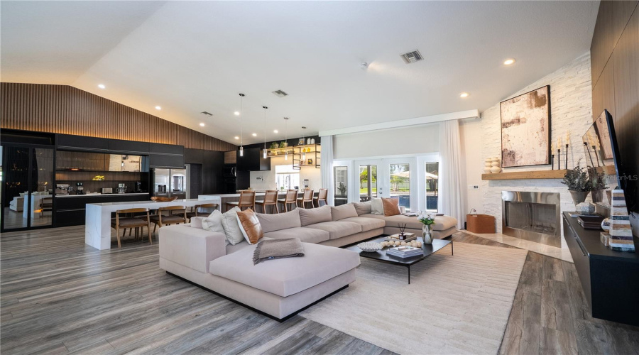 Elegant and inviting living space featuring custom Italian woodwork and a stunning fireplace.