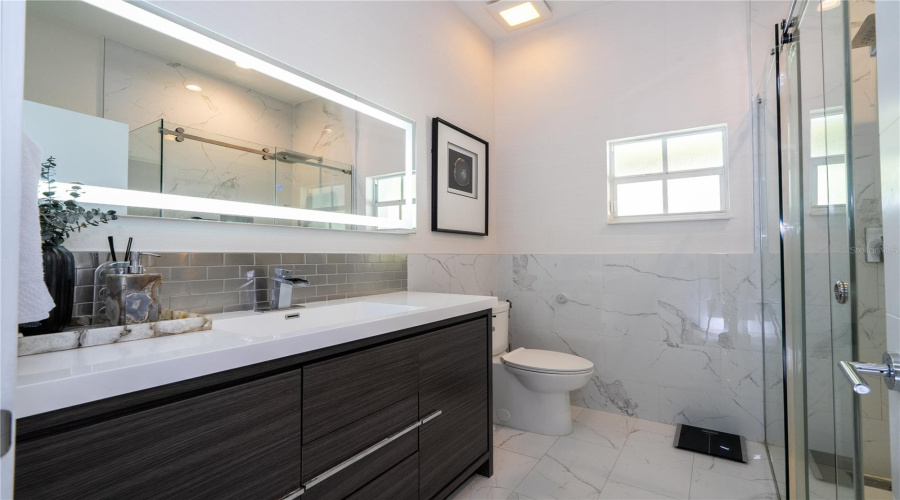 A spacious and sophisticated bathroom that attends two bedrooms.