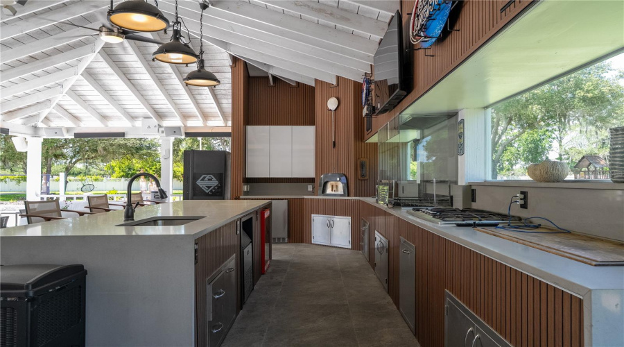 Impressive outdoor kitchen with pizza oven, grill, and full entertaining setup.