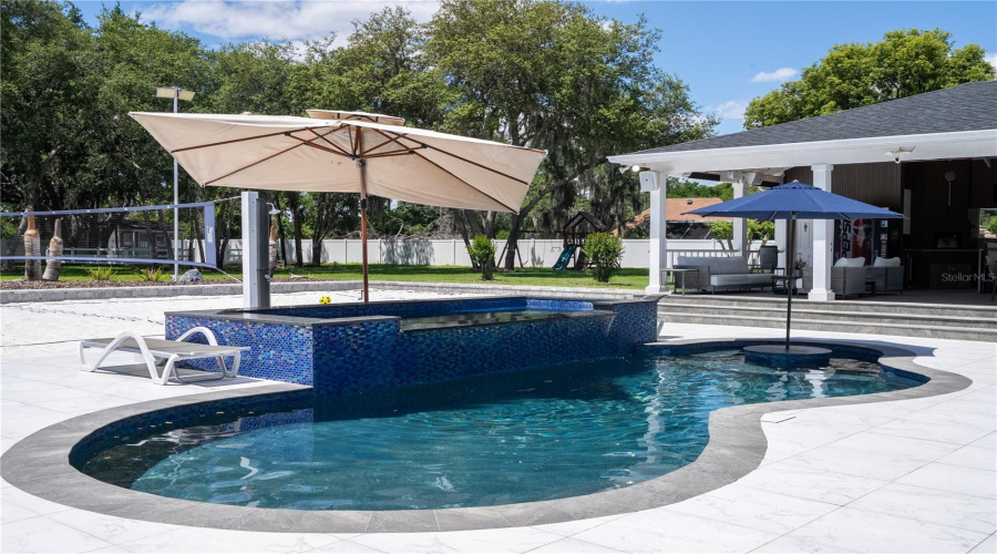 Resort-style pool and oversized spa designed for relaxation and entertaining.