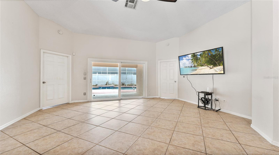 Living room with sliding doors leading to the lanai and the pool