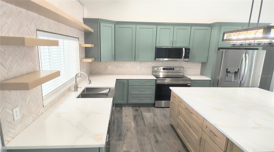 Kitchen with floating shelves & stainless steel applicances
