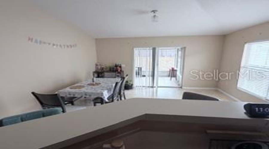 Breakfast Bar and Family Room with Slider to Screened Porch