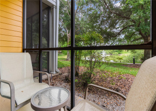 Serene views of the pond and ornamental fountain from your screen in patio