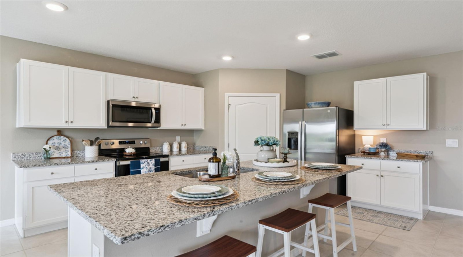 Granite counters and sink in the island are just a couple of the features this kitchen has to offer!