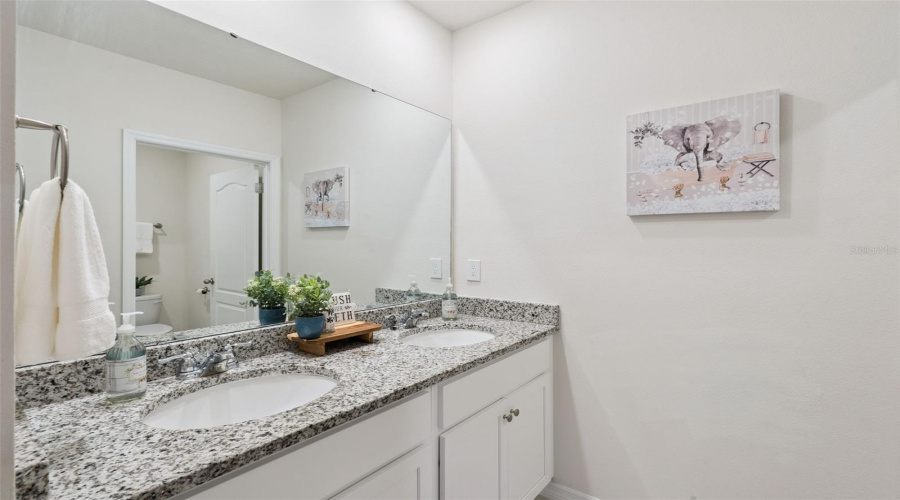 The third bathroom complete with linen closet and dual sinks is found between bedrooms 4 and 5