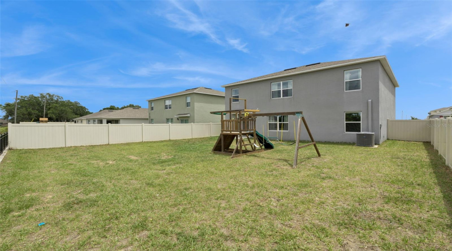 View of the back of the home from the back corner of the backyard
