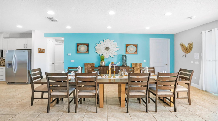 Expansive dining area with coastal-inspired styling and ample seating, perfectly suited for high-occupancy luxury vacation stays
