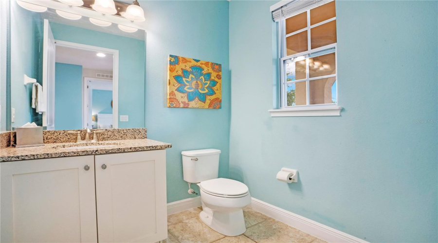 Convenient downstairs half bath accented with bright coastal-inspired finishes