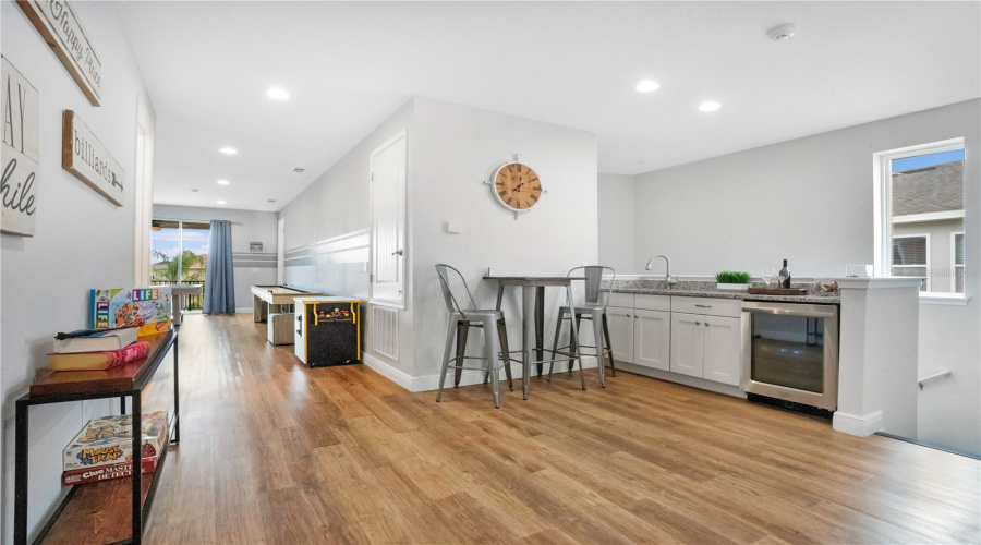 Upstairs lounge area with wet bar and additional gathering space for guests