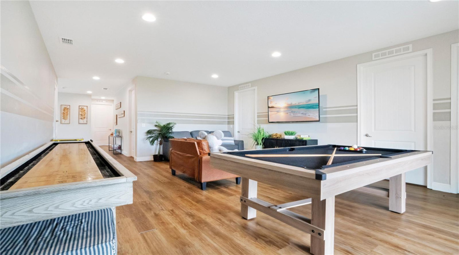 Expansive upstairs entertainment loft with brand-new pool table, shuffleboard, and classic Pac-Man cocktail arcade