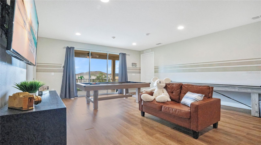 Entertainment Zone with Double Glass Sliding Doors leading out to the Balcony Space