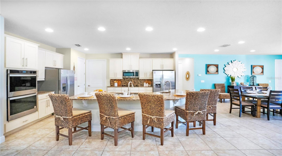 Spacious dining area positioned at the heart of the home with seating designed to comfortably accommodate large groups and vacation stays
