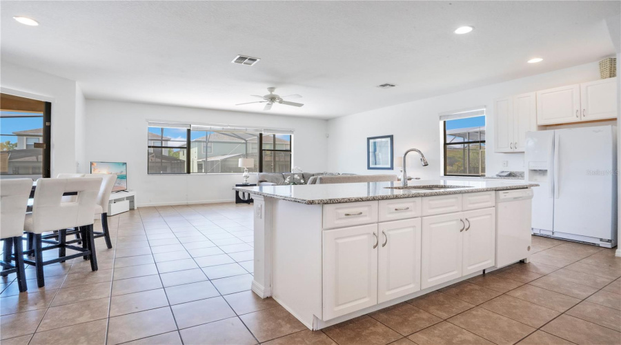 Open concept kitchen overlooking living and dining areas.